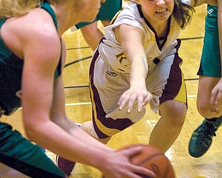 South Range sophomore Morgan Czopur lunges for the ball held by West Branch’s Melinda Trimmer during Monday’s game in Beaver Township. The Warriors won, 61-38.