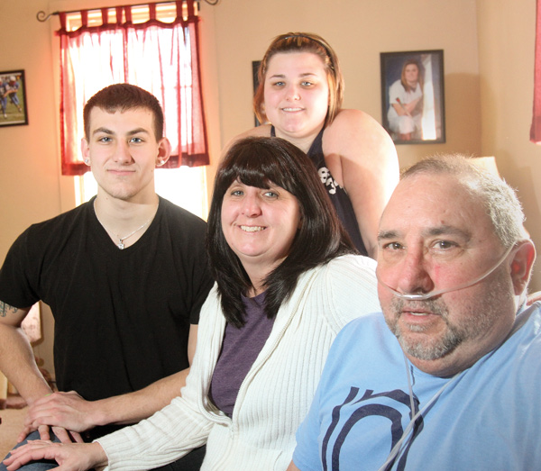 Larry Ortz, right, needs a double-lung transplant to get off the oxygen machine he is hooked to 24 hours a day. Beside the 55-year-old Austintown man are his wife, Connie, and two of his three children, Sam and Carly Ortz. A pasta dinner fundraiser, “Take a Breath for Larry,” will take place from noon to 4 p.m. Feb. 23 at Austintown Middle School, 800 S. Raccoon Road. The donation is $10 for adults and youths. Children 6 and under eat free.