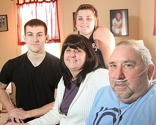 Larry Ortz, right, needs a double-lung transplant to get off the oxygen machine he is hooked to 24 hours a day. Beside the 55-year-old Austintown man are his wife, Connie, and two of his three children, Sam and Carly Ortz. A pasta dinner fundraiser, “Take a Breath for Larry,” will take place from noon to 4 p.m. Feb. 23 at Austintown Middle School, 800 S. Raccoon Road. The donation is $10 for adults and youths. Children 6 and under eat free.