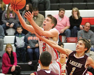 Girard’s Jim Standohar (2) goes to the basket as Pymatuning Valley’s Aaron Cross, right, defends Tuesday night. The Indians, of the All-American Conference, beat the Lakers, of the Northeastern Athletic Conference, 68-55.