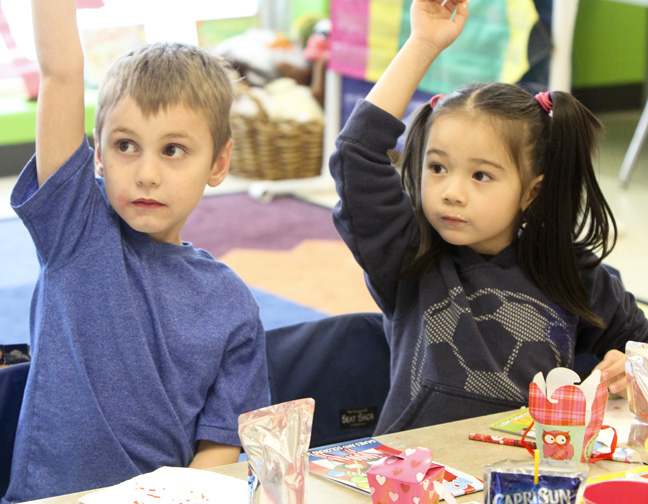William D Lewis The vindicator Austown Elem school kindergarten students Zachary Stipanovich and Eva Toropal raise their hands during a Valentines Day  party at the school 2-13.