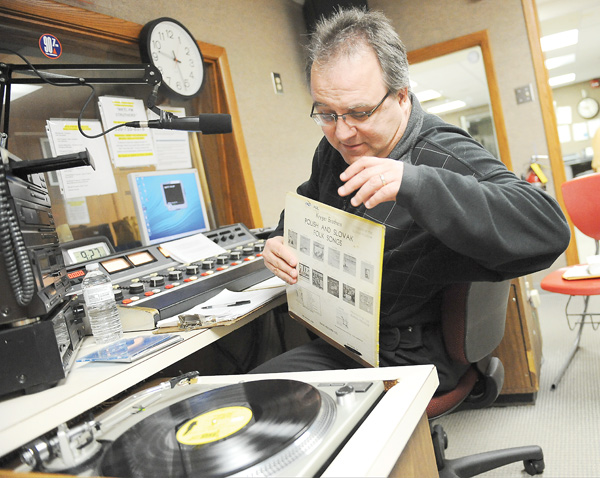 Dennis Spisak, host of “The Slovak Program,” gets ready to spin a record after a request Saturday night. Spisak has hosted the show, which runs from 9 to 11 p.m. Saturdays, for the past four years but also played polkas on WKTL 90.7 FM as a student at Struthers High School.