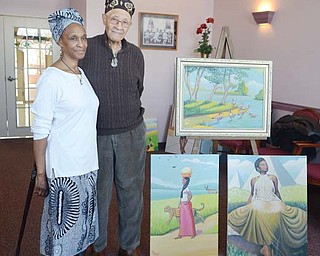 Local artist Joseph Thomas, right, stands with his wife, Gwendolyn, at Danridge’s Burgundi Manor in Youngstown, where his original artwork will be displayed for three days during his annual gallery event.