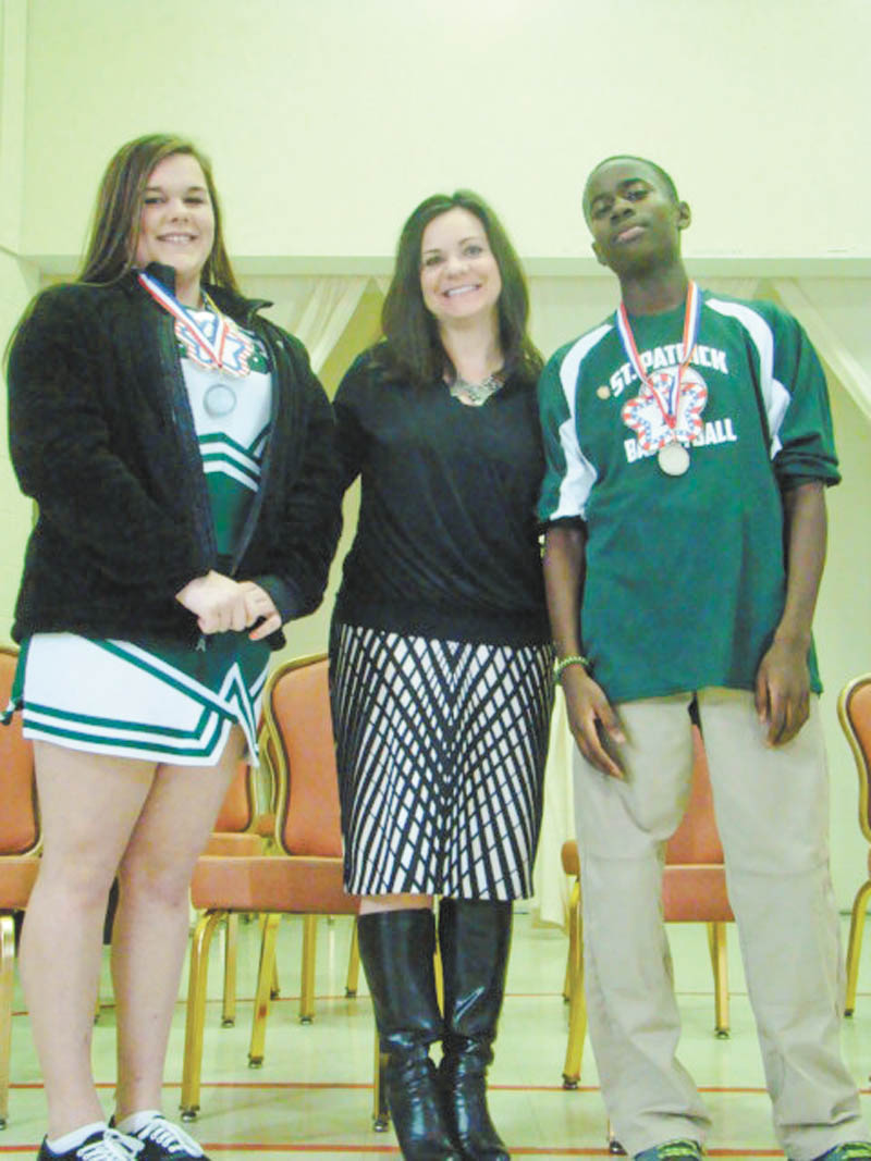 SPECIAL TO THE VINDICATOR 
St. Patrick School in Hubbard, a Lumen Christi School, revealed its top spellers after a recent spelling bee. From left are Camryn Ealy, runner-up; Jackie Venzeio, principal; and Guy-Michel Kaho, spelling bee winner. Both students are eighth-graders.
