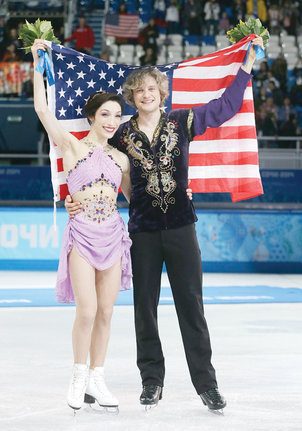 Meryl Davis and Charlie White of the United States pose for photographs after placing first in the ice dance free
dance figure skating finals Monday at the Iceberg Skating Palace during the 2014 Winter Olympics in Sochi,
Russia. The pair, who won silver in Vancouver, are the first Americans to win an ice dance gold medal.