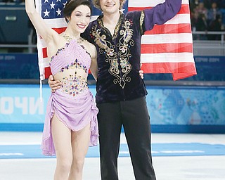 Meryl Davis and Charlie White of the United States pose for photographs after placing first in the ice dance free
dance figure skating finals Monday at the Iceberg Skating Palace during the 2014 Winter Olympics in Sochi,
Russia. The pair, who won silver in Vancouver, are the first Americans to win an ice dance gold medal.