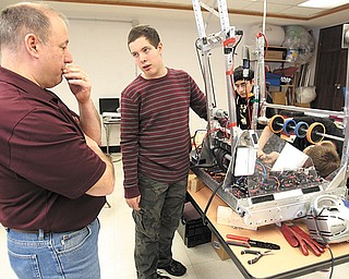 Bobby Hudock, a sophomore at Canfield High School, asks teacher Don Crum about the robot he’s constructing for the FIRST Robotics Competition. The robotics team at Canfield used Tuesday’s snow day to perfect their work, which was due by day’s end.