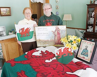 Images of St. David, daffodils and the Welsh flag and shield will be on display at the St. David’s Day banquet being planned by Rhea Crelin, left, coordinator, and John Tamplin, president of the St. David’s Society of Youngstown. The banquet March 1 celebrates Welsh heritage and the patron saint of Wales.