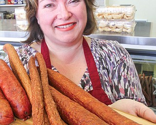 Marta Mazur, owner of Krakus Polish Deli and Bakery in Boardman, shows a sampling of the deli’s popular
kielbasa.