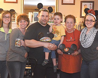 From left, Kelly Pesta, Mary Alice Sinkovich, Thomas Sinkovich Sr., Thomas Sinkovich Jr., Mary Powell and Rebecca Pesta show off souvenirs from their recent trip to the Walt Disney World Resort in Orlando, Fla.