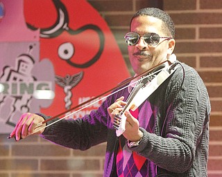 Jerald Daemyon , internationally acclaimed master violinist, lecturer, composer and recording artist, demonstrates his skills at a music workshop at Choffin Career and Technical Center. Daemyon conducted an interactive seminar for students Wednesday as part of Choffi n’s Black History Month observance.
