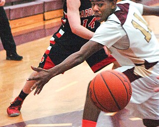 Liberty’s Cameron Clark watches as a pass by Canfield’s Mike Yourstowsky get by him during the first half of their game Tuesday at Liberty High School. The Cardinals got by the Leopards, 60-48.