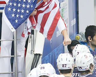 A fan congratulates the U.S. hockey team after their 5-2 win over the Czech Republic in Wednesday’s 2014 Olympic quarterfinal at the Shayba Arena in Sochi, Russia. Team USA faces Team Canada in the semifinals on Friday.