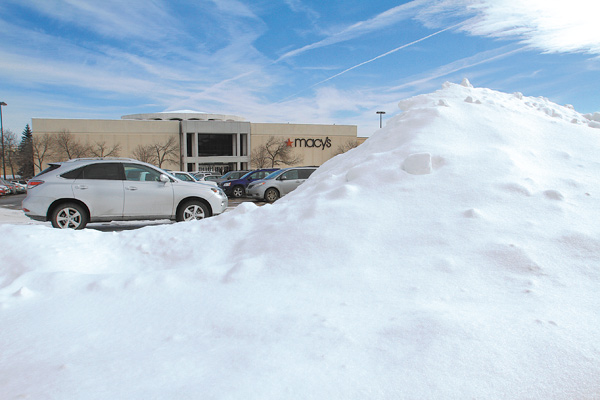 Snow mounds in the parking lot of Southern Park Mall in Boardman are beginning to melt. Higher temperatures and the threat of rain today and Friday hold potential for flooding in some parts of the Mahoning Valley.