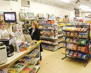 Tammy Foor, left, is the eldest daughter of Earl and Salwa Ross, the owners of Ross’ Market on East Liberty Street in Lowellville. At right is Theresa DeFrank of Lowellville. The market has been a village staple for the past 33 years, but Foor is concerned that a proposed Family Dollar three blocks away could hurt business.