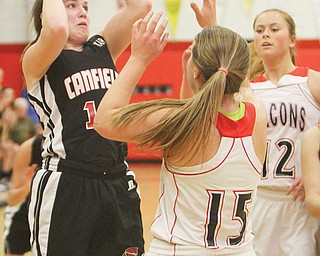Canfield’s Lynnae Whitehead looks to shoot over Fitch’s Cassier Custer (15) and Sarah Melfe (12) in a Division I sectional final Thursday at Fitch High School in Austintown. The Cardinals downed the Falcons, 53-45.