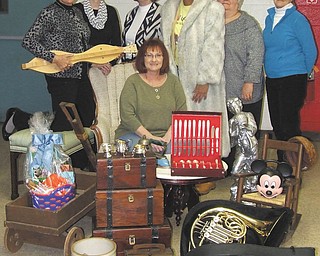 SPECIAL TO THE VINDICATOR
The Junior Group of Goodwill, made up of volunteers, prepares for its 21st annual Gala and Auction, which are set for March 7 and 8 at Stambaugh Auditorium. From left to right, Kathy Gerberry, Michele Higgins, Derrie Wilkes, Alexis Wokocha, JoAnn Trucksis, Roxie Franceschelli and Sue Miller, seated, display items that will be auctioned. 