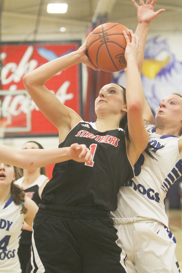 Ashleigh Ryan of Struthers puts in a layup against Lakeview defender Abby Pavlik during the second half of their Division II district semifinal on Monday at Fitch High School in Austintown. Ryan recorded a game-high 19 points with nine rebounds to help lead the Wildcats over the Bulldogs, 53-39. Struthers faces the winner of tonight’s West Branch-Ravenna contest in the district title game Friday.