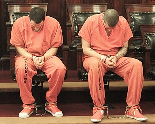 Ruben Best, 20, left, and Gary Hartman, 24, bow their heads Tuesday to avoid the media attention at their arraignments in Mahoning County Common Pleas Court. Best and Hartman are accused of supplying the drugs that killed 18-year-old Erin Trell of Boardman. Marijo Mazon, 46, of Boardman is accused of giving Trell
and a juvenile the drugs.