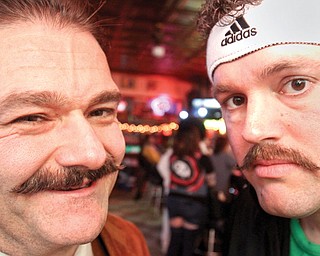 Youngstown Police officers Mike Marciano, left, and Michael Fox, sport mustaches during a party Wednesday at Royal Oaks in Youngstown. City officers on midnight turn organized a mustache contest as a fundraiser for the Michael Hartzell scholarship fund. Hartzell was a police officer killed in the line of duty in April 2003.