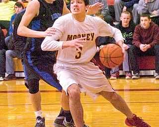 Mooney forward Ross Lanzo drives toward the basket against Lakeview defender Tom Bell during the first half of their Division II sectional semifinal Wednesday at Cardinal Mooney High School in Youngstown. The Cardinals downed the Bulldogs, 53-30.