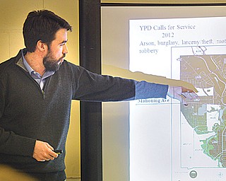 Ian Beniston, deputy director of Youngstown Neighborhood Development Corp., shows police service calls in a neighborhood during a meeting to gather community input on how to better stabilize and develop neighborhoods in the present and future.