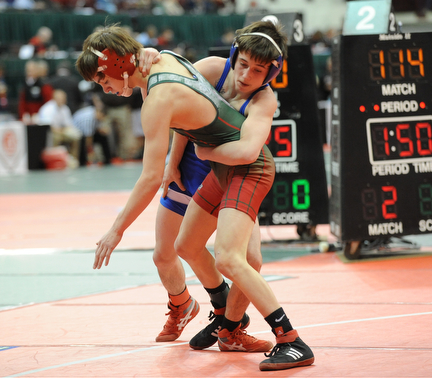 Alex Potts of East Liverpool attempts to throw Josh Venia of Toledo Central Catholic to the mat during their 106lb Division 2 championship bracket bout during the State High School Wrestling meet on February 27, 2014 at Jerome Schottenstein Center in Columbus, Ohio.