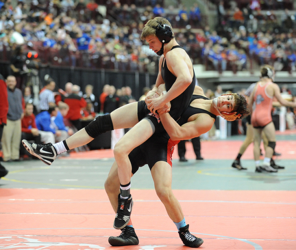 Georgio Poullas of Canfield goes for the slam of Luke Leonard of Fostoria during their 126lb Division 2 championship bracket bout during the State High School Wrestling meet on February 27, 2014 at Jerome Schottenstein Center in Columbus, Ohio.
