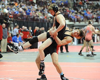 Georgio Poullas of Canfield goes for the slam of Luke Leonard of Fostoria during their 126lb Division 2 championship bracket bout during the State High School Wrestling meet on February 27, 2014 at Jerome Schottenstein Center in Columbus, Ohio.