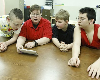        ROBERT K. YOSAY  | THE VINDICATOR..Sister Martha works with an I Pad on quick math problems. l-r  Tyler Wolfrod -Becky- Cory Fielder -  Halston Glaspell.Sister Becky Reed at Potential Developement center ...... - -30-.       ROBERT K. YOSAY  | THE VINDICATOR......... - -30-.