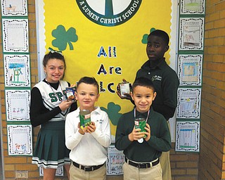 SPECIAL TO THE VINDICATOR
The students of St. Patrick School in Hubbard recently celebrated the 100th day of school by setting a goal to collect 100 cans of food for a local pantry. Some of the students participating, from the left, are Kelly Dovellos, Elijah Arnaut, Christian Arnaut and Guy-Michel Kaho.