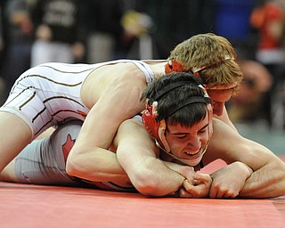 COLUMBUS, OHIO - FEBRUARY 28, 2014: Dustin Warner of Uhrichsville Claymont rides the back of Korey Frost of Canfield during their 120lb championship bracket bout during the 2014 division 2 state wrestling tournament at Schottenstein Center.