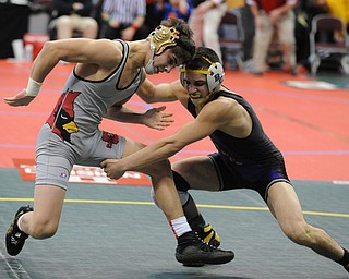 COLUMBUS, OHIO - FEBRUARY 28, 2014: Georgio Poullas of Canfield slips out of the grasp of Chandler Minnard of Bloom-Carroll and will get a reversal during their 126lb consolation bracket bout during the 2014 division 2 state wrestling tournament at Schottenstein Center.