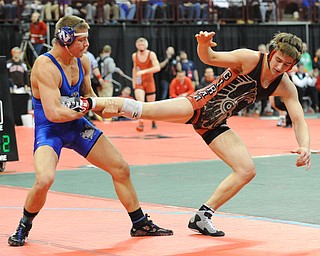 COLUMBUS, OHIO - FEBRUARY 28, 2014: Nick Cardiero of Girard attempts to hop out of bound before having his leg kicked out by Joey Meek of W. Salem Northwest during their 170lb championship bracket bout during the 2014 division 3 state wrestling tournament at Schottenstein Center.