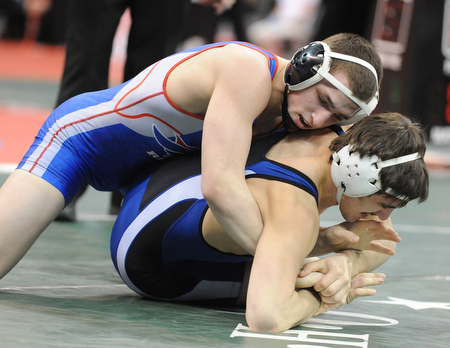 COLUMBUS, OHIO - FEBRUARY 28, 2014: Zeck Lehman of Revere rides the back of Mike Audi of Poland during their 170lb consolation bracket bout during the 2014 division 2 state wrestling tournament at Schottenstein Center.