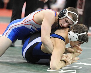 COLUMBUS, OHIO - FEBRUARY 28, 2014: Zeck Lehman of Revere rides the back of Mike Audi of Poland during their 170lb consolation bracket bout during the 2014 division 2 state wrestling tournament at Schottenstein Center.