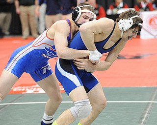COLUMBUS, OHIO - FEBRUARY 28, 2014: Mike Audi of Poland attempts to free himself from the grasp of Zeck Lehman of Revere during their 170lb consolation bracket bout during the 2014 division 2 state wrestling tournament at Schottenstein Center.