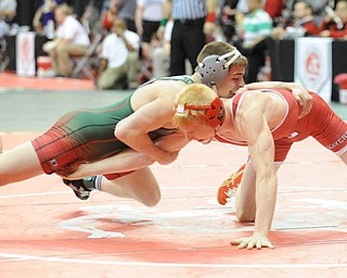 COLUMBUS, OHIO -FEBRUARY 28, 2014: Daniel Hasson of Beaver Local attempts to hold on to the leg of Josh Mossing of Toledo Central Catholic, as Mossing attempts to take his back during their 138lb championship bracket bout during the 2014 division 2 state wrestling tournament at Schottenstein Center.