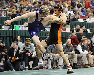 COLUMBUS, OHIO -FEBRUARY 28, 2014: David-Brian Whisler of Howland takes out the leg of Mike Repko of Vermilion before taking him to the mat during their 152lb championship bracket bout during the 2014 division 2 state wrestling tournament at Schottenstein Center.