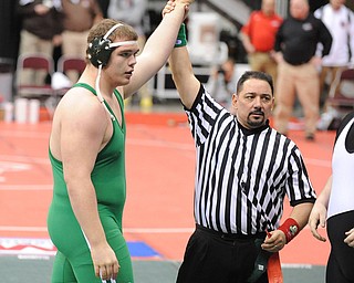 COLUMBUS, OHIO -FEBRUARY 28, 2014: Logan Sharp of West Branch has his arm raised by the referee in victory after a 285lb championship bracket bout during the 2014 division 2 state wrestling tournament at Schottenstein Center.