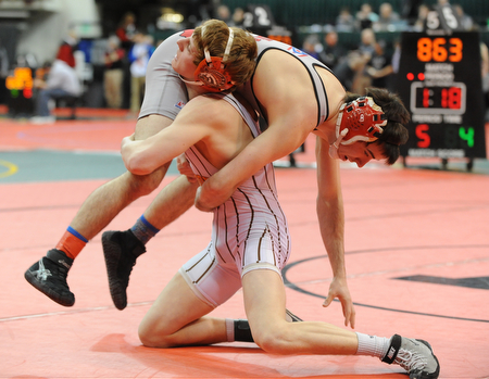 COLUMBUS, OHIO - FEBRUARY 28, 2014: Dustin Warner of Uhrichsville Claymont picks up Korey Frost of Canfield before slamming him to the mat during their 120lb championship bracket bout during the 2014 division 2 state wrestling tournament at Schottenstein Center.