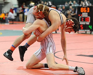 COLUMBUS, OHIO - FEBRUARY 28, 2014: Dustin Warner of Uhrichsville Claymont picks up Korey Frost of Canfield before slamming him to the mat during their 120lb championship bracket bout during the 2014 division 2 state wrestling tournament at Schottenstein Center.