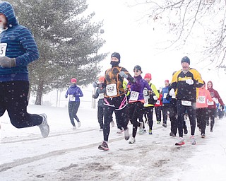 Runners watch out for ice and snow during Sunday’s Youngstown Road Runners Club’s Mill Creek Distance 5K at the Wick Recreation Area in the park.
