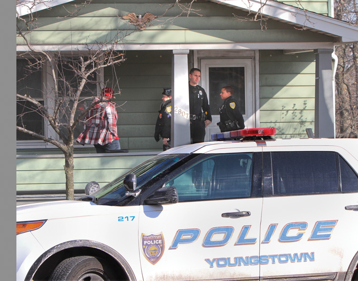 Youngstown police investigate the scene of a boy’s death Saturday on South Avenue. Officials believe the boy froze to death after falling asleep in his underwear on an unheated porch.
