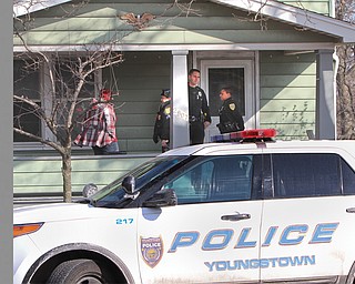 Youngstown police investigate the scene of a boy’s death Saturday on South Avenue. Officials believe the boy froze to death after falling asleep in his underwear on an unheated porch.
