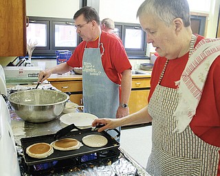 Jim Bishop and Linda Nehls make pancakes for a Shrove Tuesday pancake supper and party at Grace Lutheran Church in Hubbard. Some 140 people were served and more than 400 pancakes flipped.