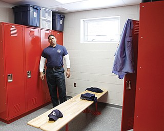 Capt. Perry Harrison of the Youngstown Fire Department shows off the new locker room for firefighters on duty at the new Station 9 on East Midlothian Boulevard. City officials cut the ribbon for the new station Wednesday.