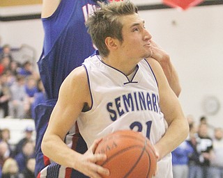 Poland’s Kyle Dixon goes to the hoop past Ravenna’s Michael Boltz during their Division II district semifinal
Wednesday at Warren Harding High. Dixon posted 15 points for the Bulldogs, who downed the Ravens, 64-52.