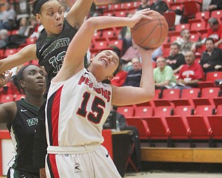Youngstown State’s Heidi Schlegel tries to control the ball under pressure from Wright State defenders including Ivory James (13) during their game Wednesday at Beeghly Center. Schlegel posted 24 points with 15 rebounds for the Penguins, who fell to the Raiders, 85-70.