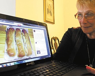 Bobbi Allen checks out her Facebook page titled "Recipes of Youngstown." Photo by William D. Lewis/The Vindicator